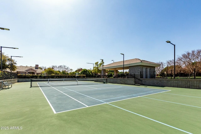 view of tennis court with fence