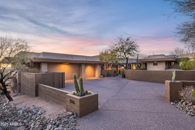 9216 E Sky Line Dr, Scottsdale, AZ 85262 - view of front of home with an attached garage, stucco siding, and driveway