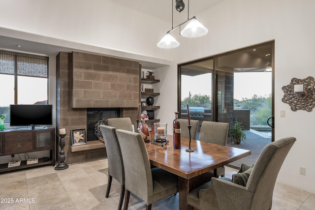 9216 E Sky Line Dr, Scottsdale, AZ 85262 - dining space with a fireplace and a high ceiling