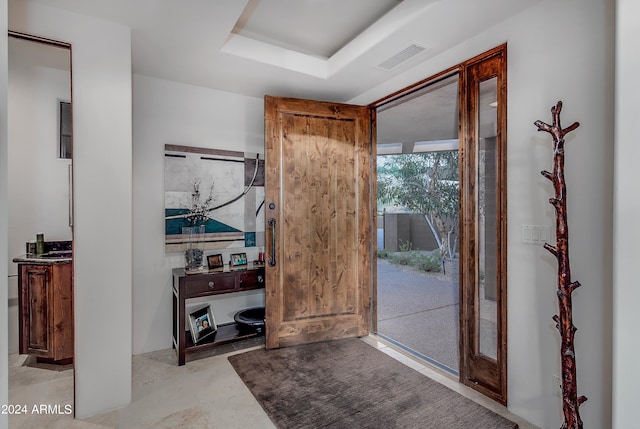 entryway featuring a tray ceiling