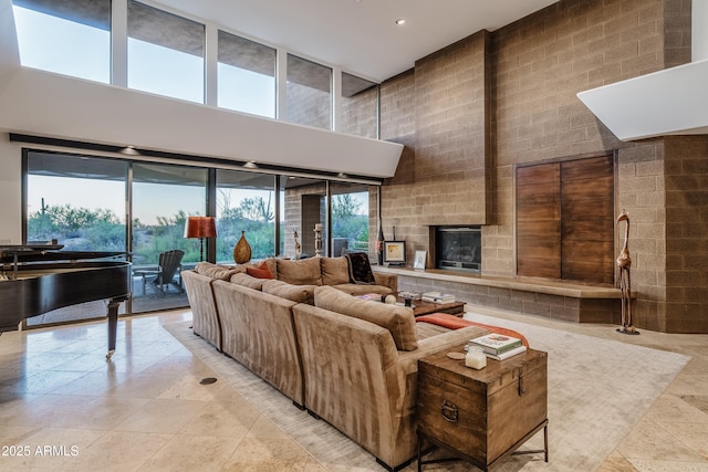 9216 E Sky Line Dr, Scottsdale, AZ 85262 - living area with a high ceiling, recessed lighting, a fireplace, and stone tile floors