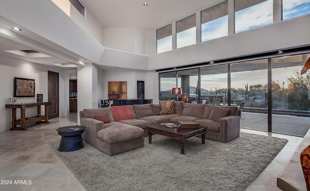 living room with a towering ceiling and plenty of natural light