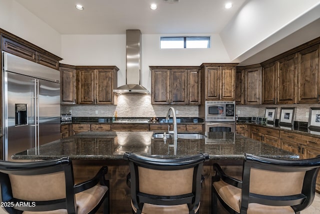 9216 E Sky Line Dr, Scottsdale, AZ 85262 - kitchen with wall chimney range hood, built in appliances, a sink, decorative backsplash, and recessed lighting