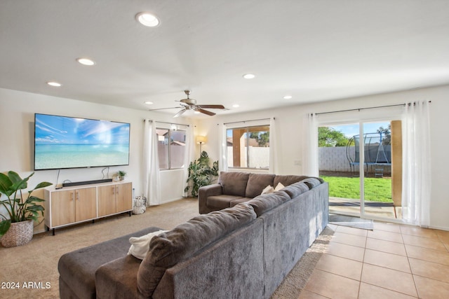 living room with ceiling fan and light tile patterned flooring