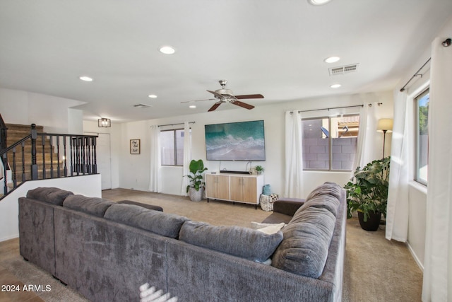 carpeted living room featuring ceiling fan