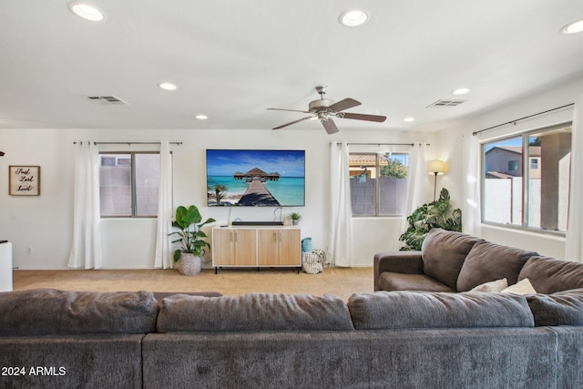 carpeted living room featuring ceiling fan