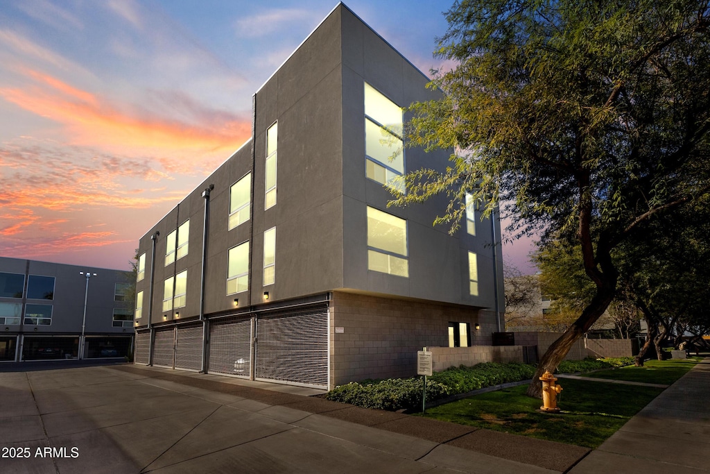 view of outdoor building at dusk