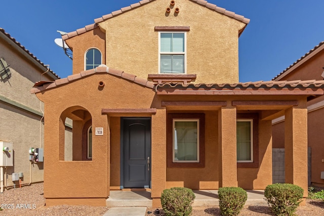 mediterranean / spanish-style home with a tile roof and stucco siding