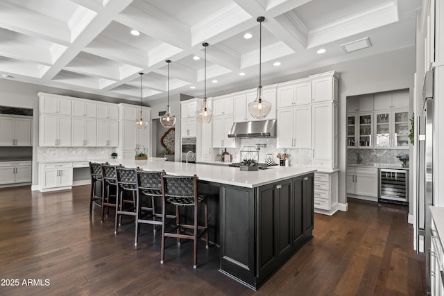 5415 E Chaparosa Way, Cave Creek, AZ 85331 - kitchen featuring under cabinet range hood, wine cooler, tasteful backsplash, white cabinets, and recessed lighting