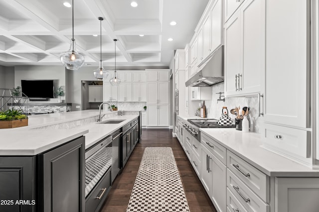 5415 E Chaparosa Way, Cave Creek, AZ 85331 - kitchen featuring a sink, stainless steel gas cooktop, under cabinet range hood, white cabinetry, and beamed ceiling
