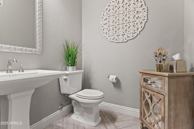5415 E Chaparosa Way, Cave Creek, AZ 85331 - half bathroom featuring baseboards, toilet, and a sink