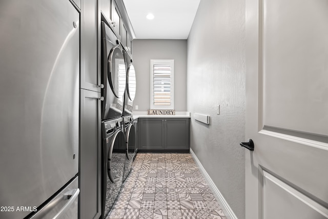 5415 E Chaparosa Way, Cave Creek, AZ 85331 - laundry room featuring cabinet space, estacked washer and dryer, baseboards, and light tile patterned floors