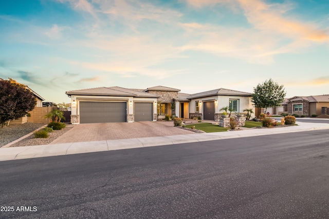 5415 E Chaparosa Way, Cave Creek, AZ 85331 - prairie-style house featuring stone siding, driveway, a garage, and stucco siding