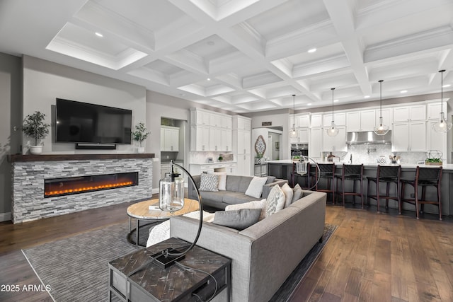 5415 E Chaparosa Way, Cave Creek, AZ 85331 - living area featuring dark wood-style flooring, recessed lighting, a stone fireplace, beam ceiling, and coffered ceiling