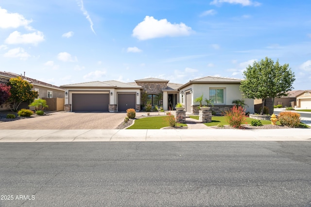 5415 E Chaparosa Way, Cave Creek, AZ 85331 - prairie-style house with stone siding, decorative driveway, stucco siding, a garage, and a tile roof