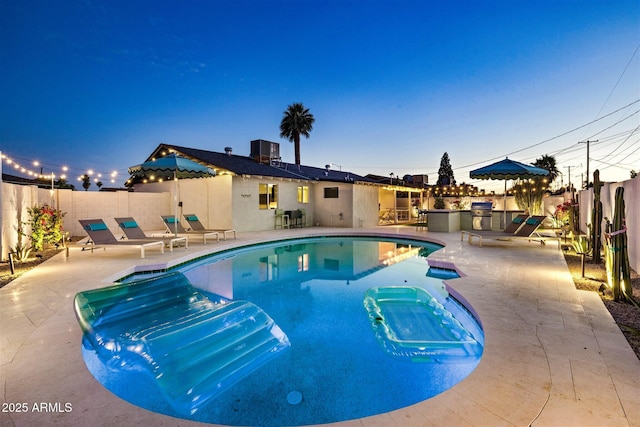 view of pool with a fenced in pool, cooling unit, a patio area, and a fenced backyard