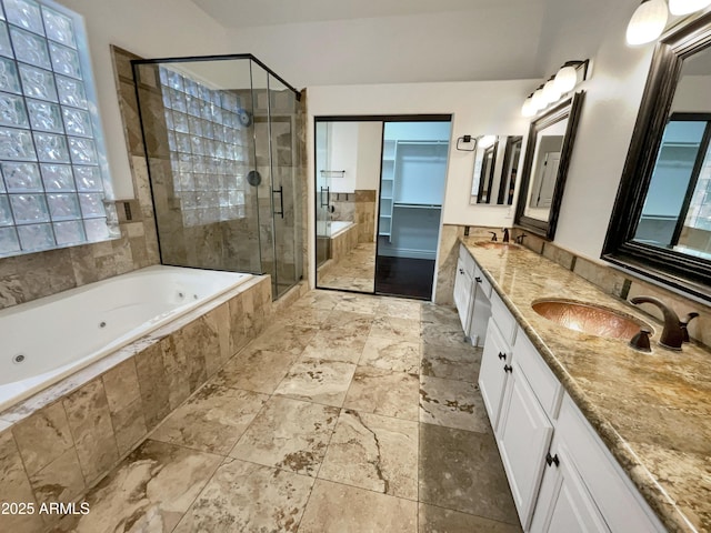 bathroom featuring vanity and separate shower and tub