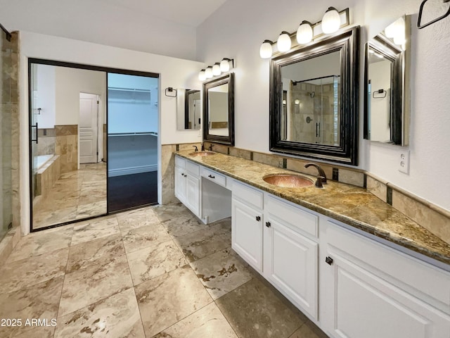 bathroom featuring vanity and shower with separate bathtub