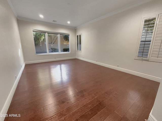 empty room featuring ornamental molding and dark hardwood / wood-style flooring