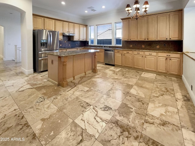 kitchen with a kitchen island, decorative backsplash, stainless steel appliances, crown molding, and light brown cabinets