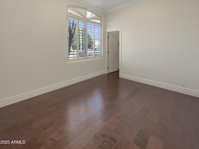 unfurnished room featuring ornamental molding and dark wood-type flooring