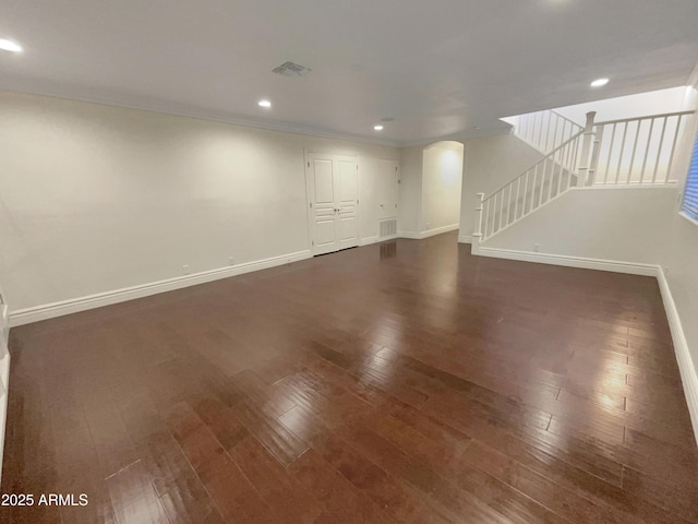 unfurnished living room with dark hardwood / wood-style flooring