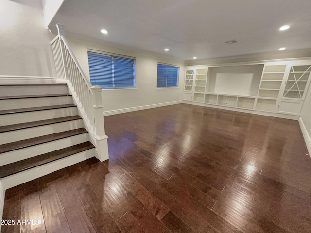 unfurnished living room with built in features and dark hardwood / wood-style floors