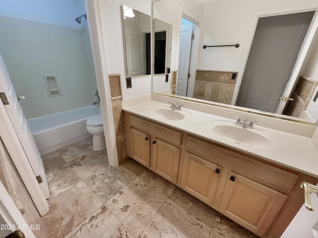 full bathroom featuring vanity, toilet, and washtub / shower combination