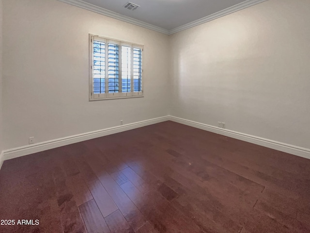 spare room featuring hardwood / wood-style flooring and crown molding