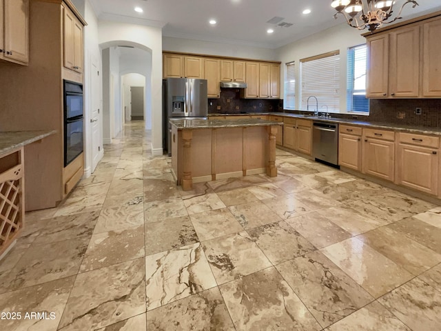 kitchen featuring backsplash, sink, stainless steel appliances, and a center island