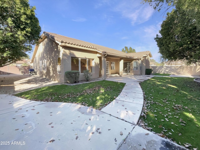 rear view of house featuring a yard