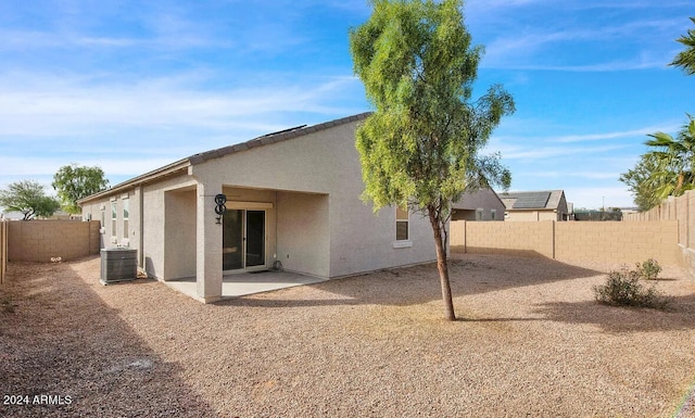 rear view of property with a patio and cooling unit