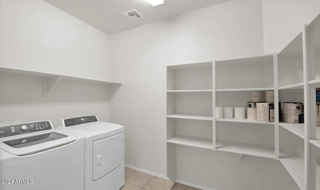 laundry room featuring light tile patterned floors and separate washer and dryer