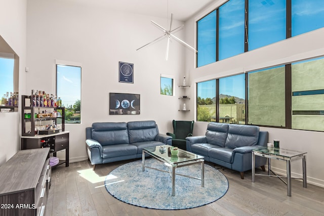 living room with a high ceiling and hardwood / wood-style flooring