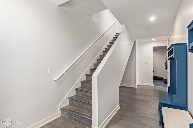 staircase with wood-type flooring