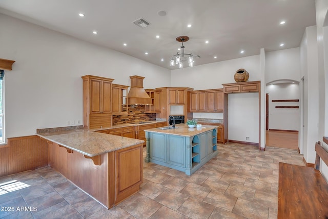 1925 W Tanya Trl, Phoenix, AZ 85086 - kitchen with open shelves, custom range hood, light stone countertops, a towering ceiling, and brown cabinetry