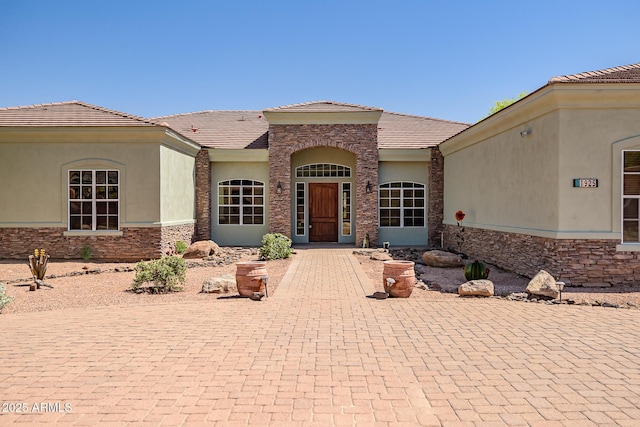 1925 W Tanya Trl, Phoenix, AZ 85086 - property entrance featuring stone siding, stucco siding, and a tiled roof