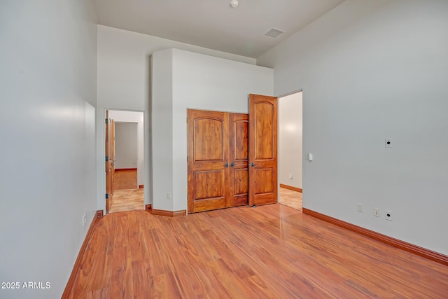 1925 W Tanya Trl, Phoenix, AZ 85086 - unfurnished bedroom with light wood-type flooring, a towering ceiling, and ensuite bathroom