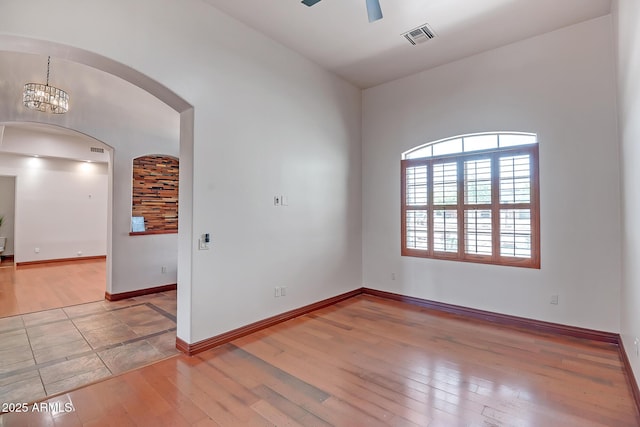 1925 W Tanya Trl, Phoenix, AZ 85086 - unfurnished room with hardwood / wood-style flooring, arched walkways, and a ceiling fan