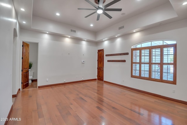 1925 W Tanya Trl, Phoenix, AZ 85086 - empty room featuring a ceiling fan, hardwood / wood-style floors, a tray ceiling, and recessed lighting