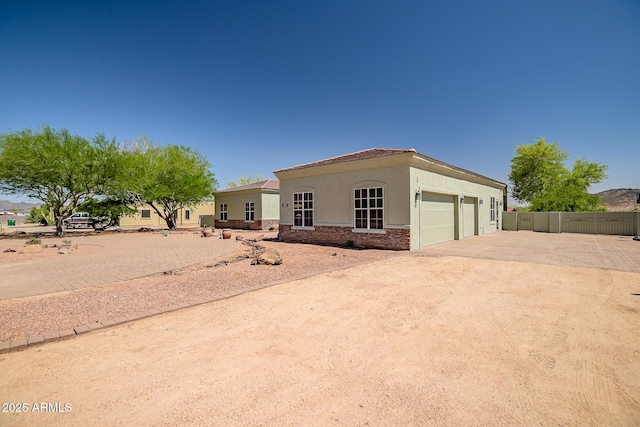 1925 W Tanya Trl, Phoenix, AZ 85086 - mediterranean / spanish-style home featuring stucco siding, driveway, a garage, and stone siding