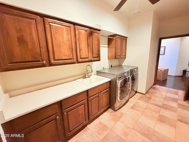 laundry room featuring visible vents, ceiling fan, a sink, cabinet space, and separate washer and dryer