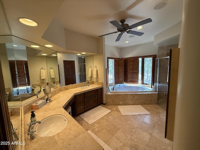 bathroom with a bath, double vanity, a sink, and a shower stall