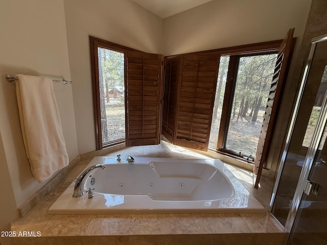 full bath with a tub with jets and a shower stall
