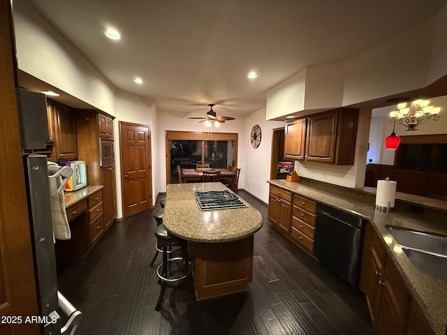 kitchen with a center island, ceiling fan, dark wood-type flooring, and stainless steel appliances