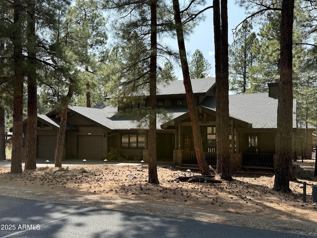 view of front of house featuring a porch and a garage