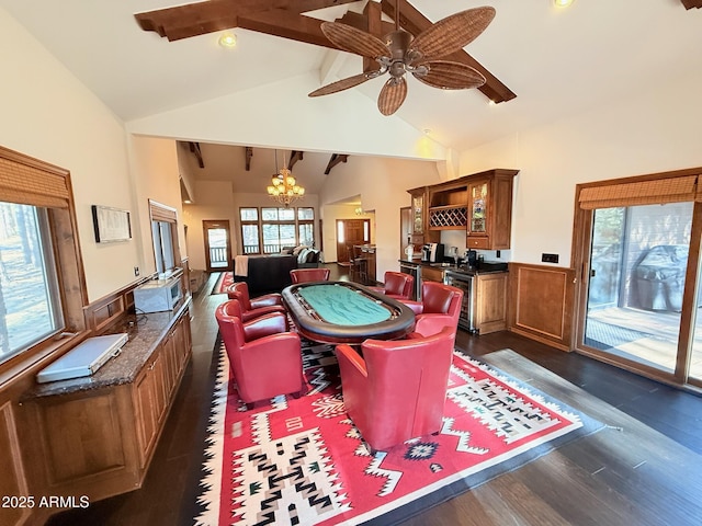 rec room featuring beam ceiling, indoor bar, wainscoting, ceiling fan with notable chandelier, and dark wood-style flooring