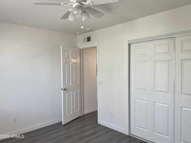 143 S Mountain Rd, Apache Junction, AZ 85120 - unfurnished bedroom featuring dark wood-style flooring, a closet, and ceiling fan