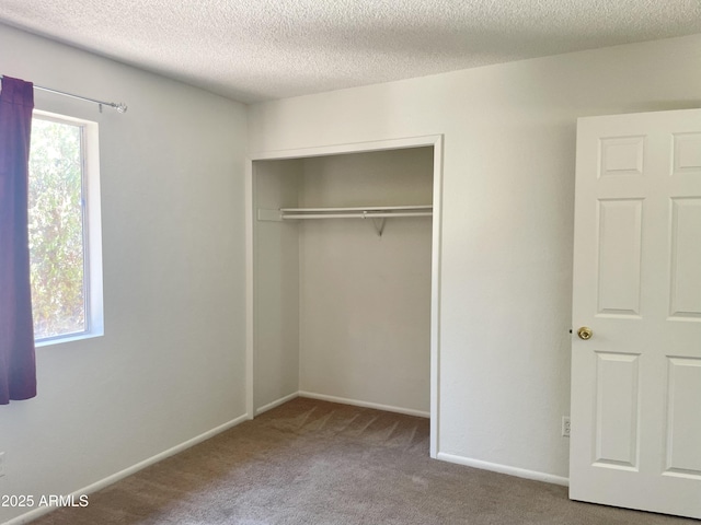 143 S Mountain Rd, Apache Junction, AZ 85120 - unfurnished bedroom featuring carpet floors, a closet, and a textured ceiling