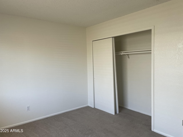 143 S Mountain Rd, Apache Junction, AZ 85120 - unfurnished bedroom with carpet, a closet, and a textured ceiling